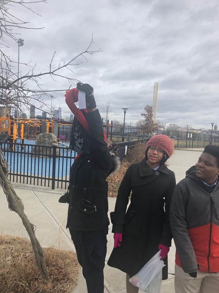 DLEACS students hang scarves on trees in Berry Lane Park.